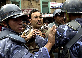 A protester argues with the police during a march on Democracy Day in Kathmandu on Friday