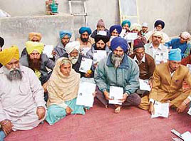 Relatives of Indian youths languishing in Pak jails show documents establishing their identity in Moga on Saturday.