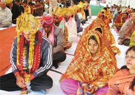 Couples being married at a ceremony in Ludhiana on Sunday