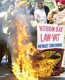 Local businessmen and traders protest against VAT in New Delhi on Sunday. 