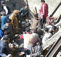 People remove debris form a damaged building in Jalandhar on Sunday.