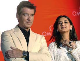 Irish-born actor and global ambassador for the Swatch Watch Group Omega products Pierce Brosnan (James Bond), along with Indian ambassador and actress Sonali Bendre (R), launch the latest Omega Constellation Double Eagle watch in Mumbai on Monday. 