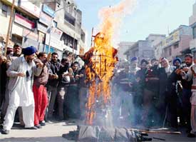 Activists of the Punjab Pardesh Beopar Mandal burn an effigy of VAT during a bandh in Ludhiana on Monday