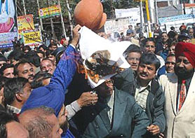 Traders and industrialists of Jalandhar burn copies of the VAT document on Monday to register their protest against its proposed implementation from April 1.