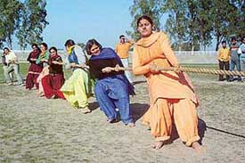 Girl students of Punjabi University participate in the tug of war competition during the Inter-Hostel Athletic Meet on the university campus in Patiala