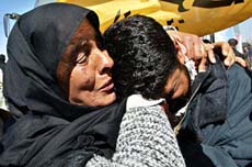 A released Palestinian prisoner kisses the hand of his mother after he was released from an Israeli jail at the Erez checkpoint north of Gaza Strip on Monday.