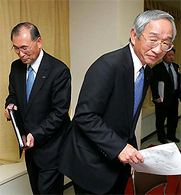 Newly named Toshiba Corp President Atsutoshi Nishida, left, and outgoing President Tadashi Okamura leave a press conference announcing the new appointment at the Japanese electronics makers headquarters in Tokyo on Tuesday