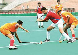 Haryana AG player being checked by UP AG players during the inter AG hockey championship on Wednesday. 