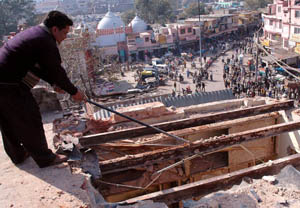 An MCD employee clearing an unauthorised construction at Chandni Chowk in the Capital.