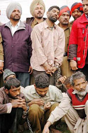 The Bangalle tribesmen, accused of several murders in Punjab, in the custody of Ludhiana police on Monday. 