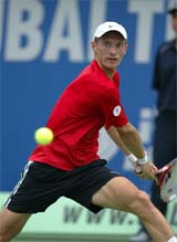 Russian Nikolay Davydenko returns the ball to Slovakia's Dominik Hrbaty in the first round of the Dubai Open on Wednesday