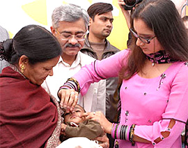 Tennis ace Sania Mirza giving polio drops to a child at a function organised by Rotary Club at Sriniwas Puri dispensary in the Capital 