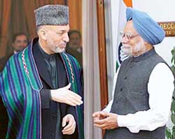 Prime Minister Dr Manmohan Singh greets Afghan President Hamid Karzai before an official meeting in New Delhi on Thursday. 