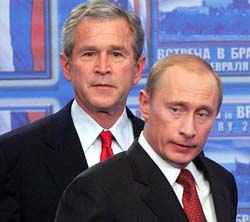 Russian President Vladimir Putin and US President George W. Bush look at journalists after their meeting in Bratislava on Thursday.