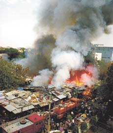Fire tenders trying to put out a fire that engulfed jhuggis in R.K. Puram in the Capital