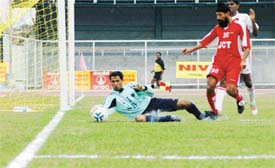 Harshal Rehman of the State Bank of Travancore, Thiruvananthapuram foils attempt of Surjit Singh of JCT Mills at the 9th National Football League match played at Guru Nanak Stadium, Ludhiana 