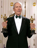 Actor-director Clint Eastwood holds his two Oscar statuettes at the 77th annual Academy Awards in Hollywood on Sunday