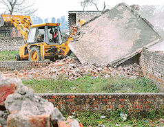 Illegal structures being demolished by the enforcement staff of UT Estate Office at Mani-Majra