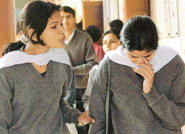 A student of Class XII tries to console her friend after taking their first examination at DAV School, Sector 15, Chandigarh, on Tuesday.