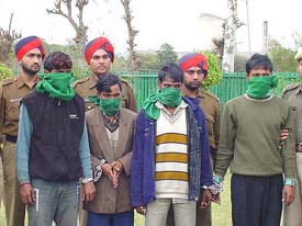 Four migrants allegedly involved in the Ludhiana train robbery being paraded before the media in Chandigarh