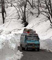 A vehicle moves towards Patnitop after the key national highway was opened to traffic following a gap of 13 days on Wednesday. 