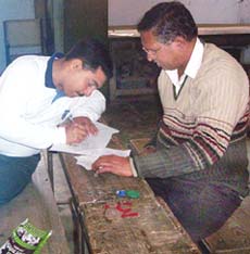 Examinees busy sorting out cheating material found in the toilet of KFC Senior Secondary School in Pathankot. 