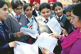 A teacher discusses the social science paper outside an examination centre in Sector 16, Chandigarh