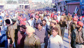 The police clears a blockade set up by one of the groups in the New Kundan Puri area where clashes between two groups took place on Thursday evening