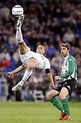 RealMadrid's Brazilian defender tries to connect a back volley as Real Betis player Joaquin Sanches looks on during their Spanish league match in Madrid on Wednesday