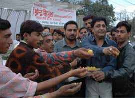 Supporters of Mr Bhupinder Singh Hooda distribute ladoos in Chandigarh after Congress President Sonia Gandhi announced his name as Chief Minister of Haryana.