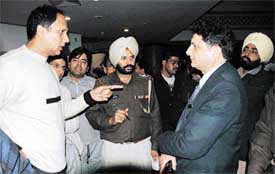 Policemen question the chief security officer of Hotel Park Plaza, in connection with the video-filming incident