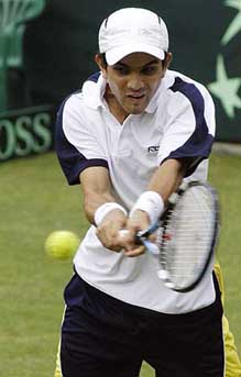 Indias Harsh Mankad hits a return shot to Chinas Sun Peng during a Davis Cup match in New Delhi on Friday.