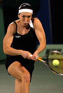 Jelena Jankovic of Serbia returns the ball to Sania Mirza of India
