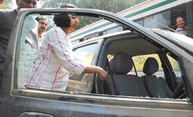 A woman showing her damaged car after the explosion at the junction of Barakhamba Road in the Capital on Saturday.