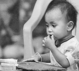 A girl taking food at a tsunami relief camp in Car Nicobar