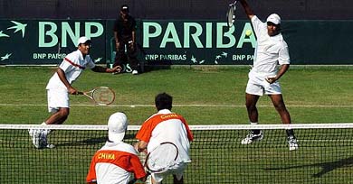Indias Leander Paes hits a return as team-mate Mahesh Bhupathi looks on during their Davis Cup doubles tie against Chinas Wang Yu and Zhu Beng-Qiang in New Delhi on Saturday
