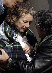 Italian hostage Giuliana Sgrena receives help as she arrives at the Ciampino Airport in Rome