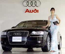 A model poses with Germanys Audi Motors new vehicle, the A8 6.0 12-cylinder, during an unveiling ceremony at a hotel in Seoul on Sunday.