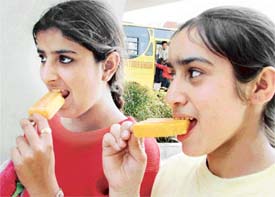 City girls enjoy candies to beat the heat in Ludhiana on Sunday