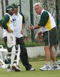Pakistan coach Bob Woolmer gives tips to Pakistan batsmen during a practice session at the PCA stadium in Mohali