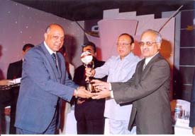 Jalandhar-based industrialist Shital Vij receives a gold trophy awarded to his company, Shital Fibres, for the export of the largest quantity of manmade fibre blankets.