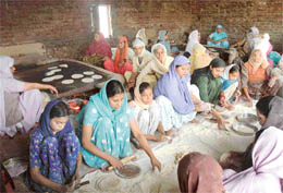 Women prepare chapattis at the Sohana Singh Shahidan Gurdwara in Mohali. 