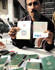 A Crime Branch officer showing the fake passports in the Capital