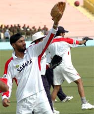 Harbhajan Singh and other Indian players during a practice session on the eve of the first Test against Pakistan in Mohali on Monday. 