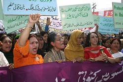 Activists of human rights groups chant slogans during a rally