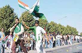 Pakistani cricket fans have a round of PCA Stadium with Indian and Pakistani flags in hands before the start of match at PCA Stadium in Mohali on Tuesday