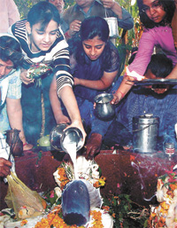 Devotees pour milk on Shivlinga to celebrate Shiv Ratri at a temple in the Capital on Tuesday