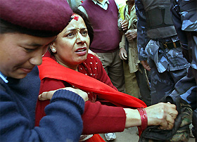 A policewoman arrests a suspected activist in Kathmandu on Tuesday