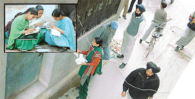 Girl students help each other out during an exam