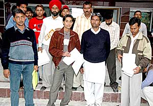 Duped candidates with their documents outside Sat Narayan Associates in Sector 8, Chandigarh, on Wednesday.